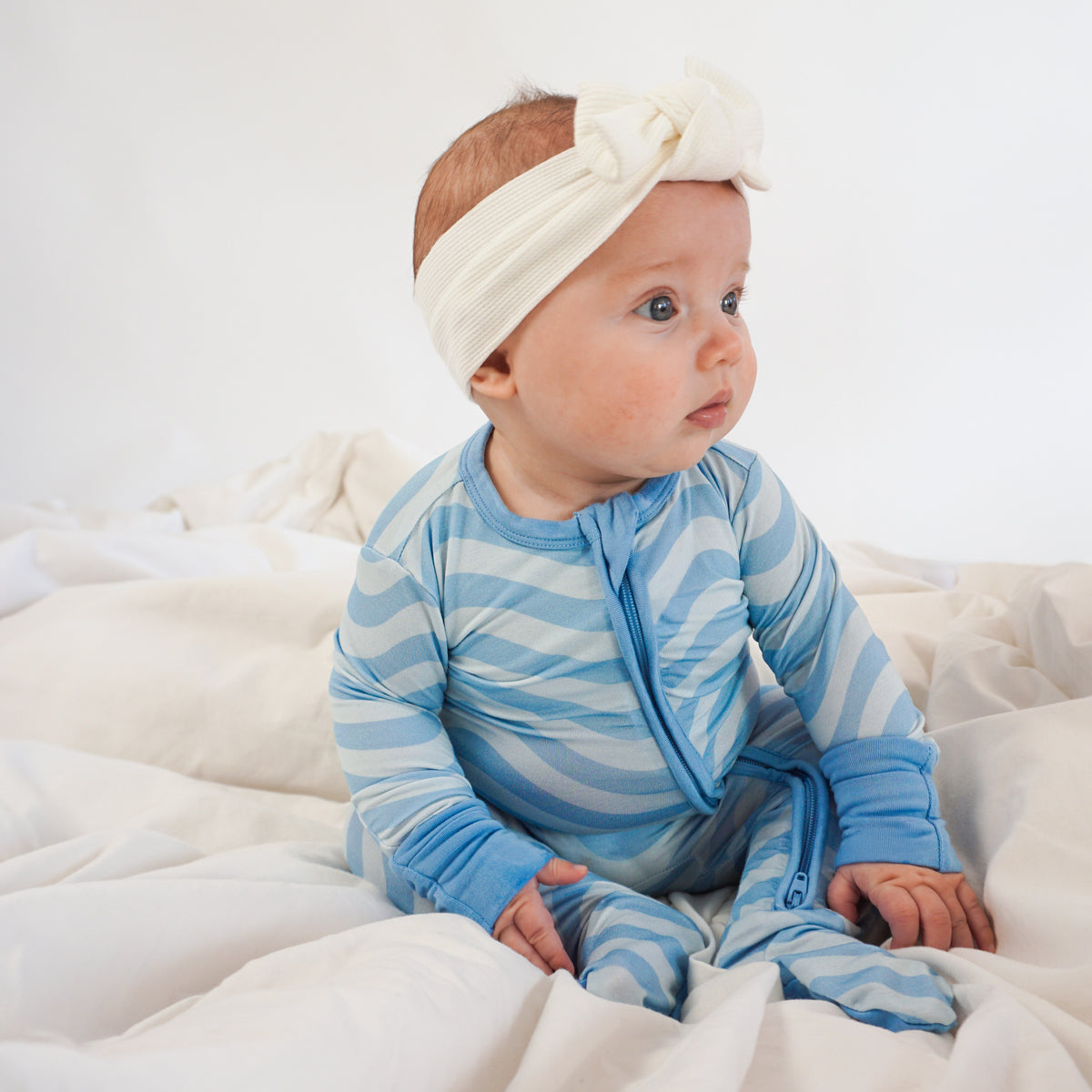 Soft bamboo baby pajamas in blue wave print, eco-friendly sleepwear.
