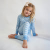Soft bamboo baby pajamas in blue wave print, eco-friendly sleepwear.