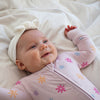 Soft bamboo baby pajamas in pink floral print, eco-friendly sleepwear.