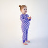Soft bamboo baby pajamas in purple checkered print, eco-friendly sleepwear.
