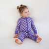 Soft bamboo baby pajamas in purple checkered print, eco-friendly sleepwear.